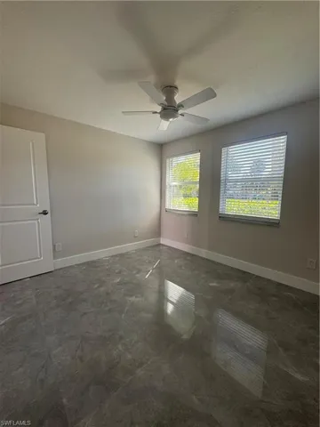 Unfurnished room featuring baseboards and a ceiling fan