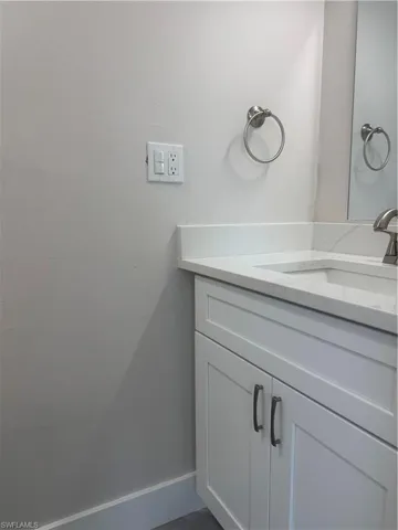 Bathroom featuring vanity and baseboards
