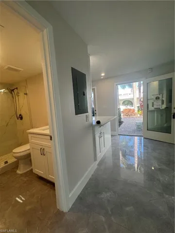 Hall with electric panel and dark marble finish flooring