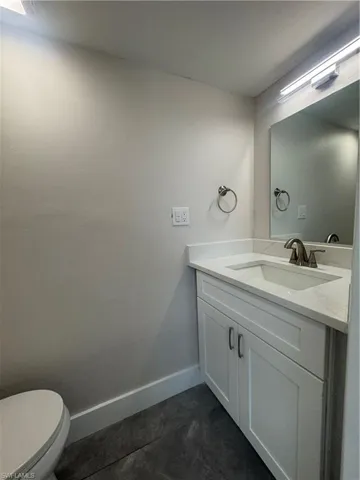 Half bath with vanity and toilet