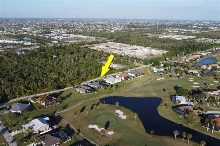 Aerial view of property's location with a nearby body of water and nearby suburban area