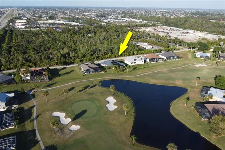 Aerial overview of property's location with a nearby body of water and nearby suburban area