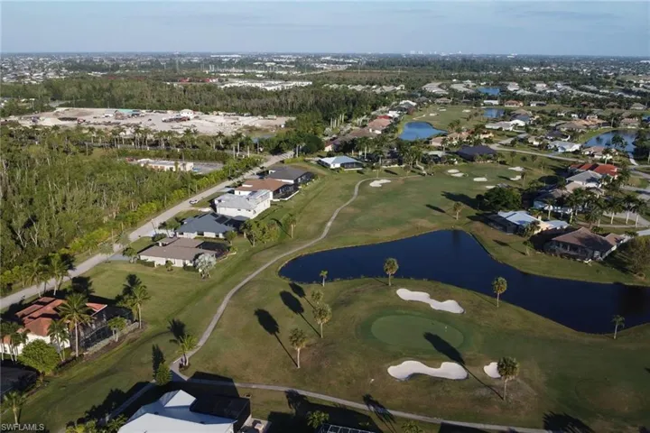 Aerial overview of property's location featuring a large body of water and nearby suburban area