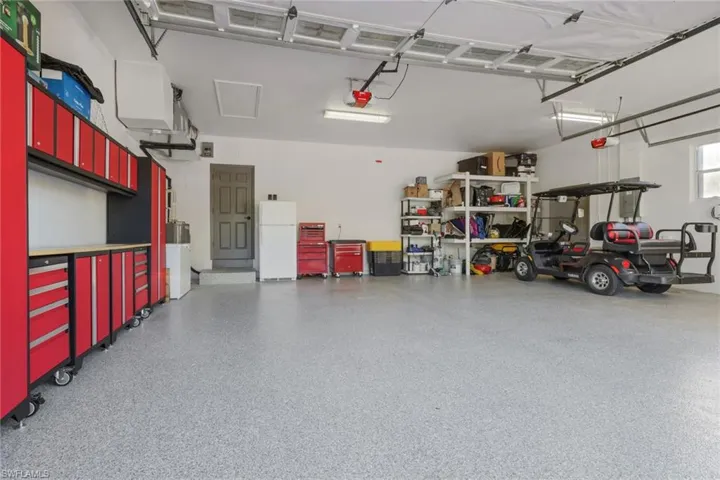 Garage featuring freestanding refrigerator