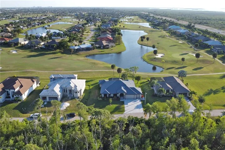 Aerial overview of property's location with nearby suburban area and a golf course