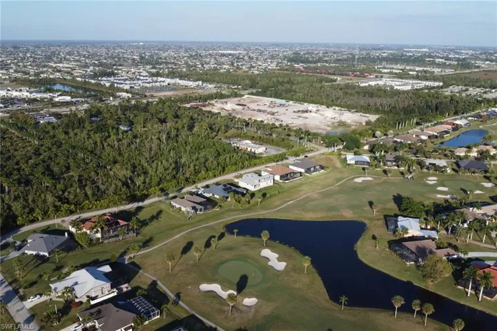 Aerial view of property's location with a nearby body of water and nearby suburban area