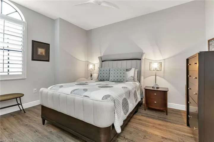 Bedroom with ceiling fan and hardwood / wood-style floors