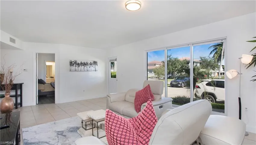 Living room featuring a wealth of natural light and light tile patterned floors