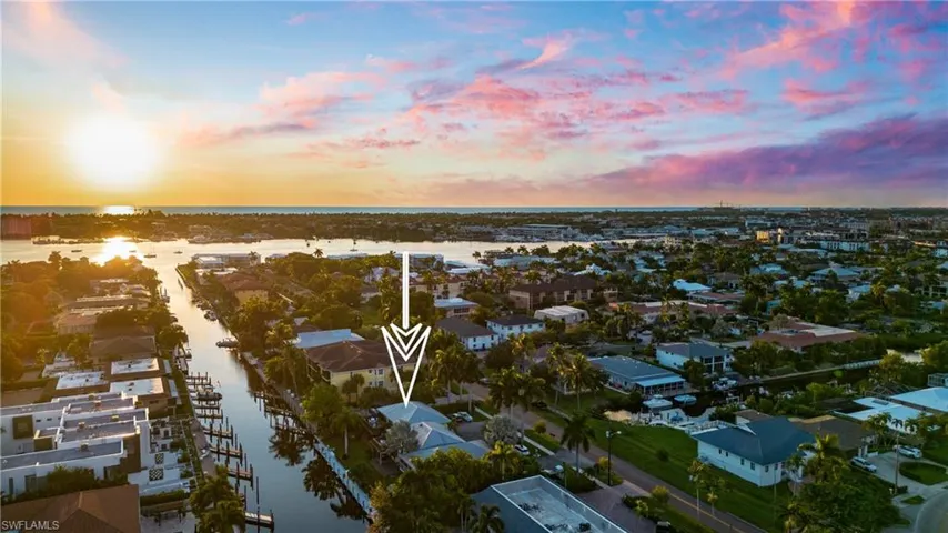Aerial view at dusk featuring a water view