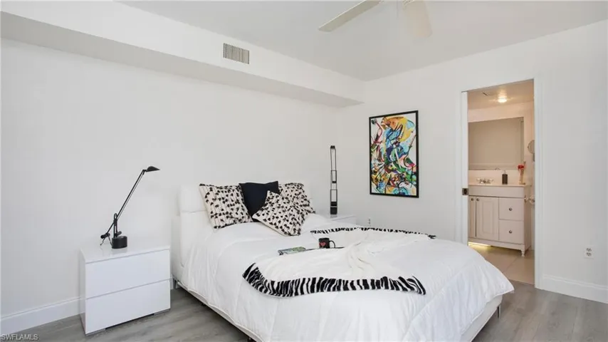 Bedroom featuring connected bathroom, ceiling fan, and hardwood / wood-style flooring