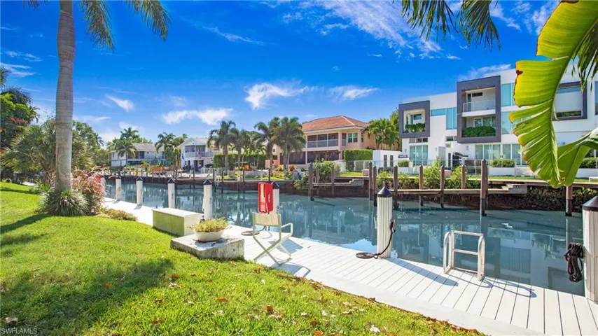 Dock area featuring a water view and a yard