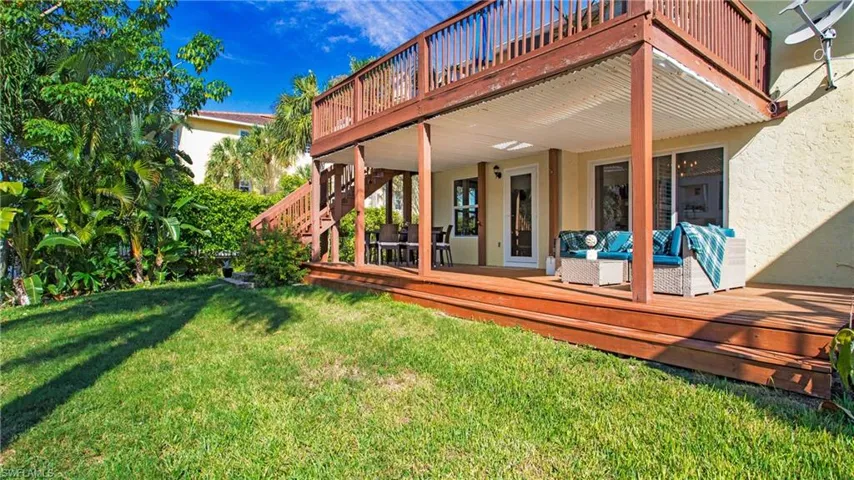 Rear view of property featuring outdoor lounge area, a deck, and a yard