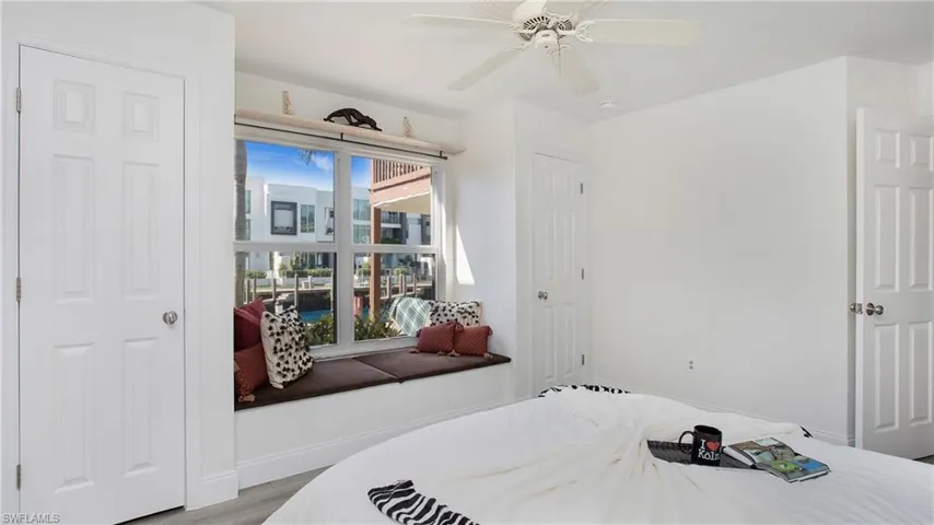 Bedroom with light hardwood / wood-style floors and ceiling fan