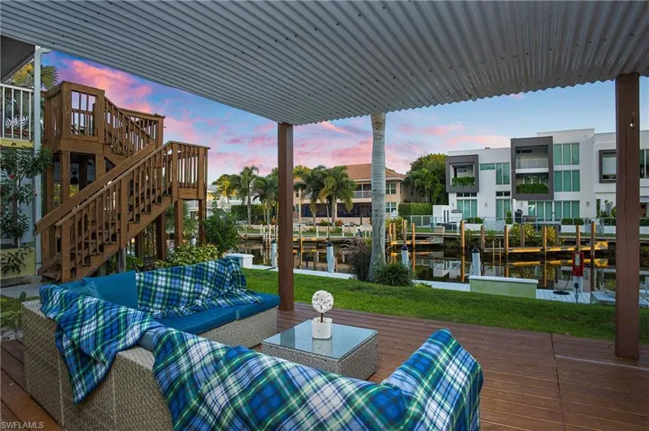 Deck at dusk with an outdoor hangout area and a water view