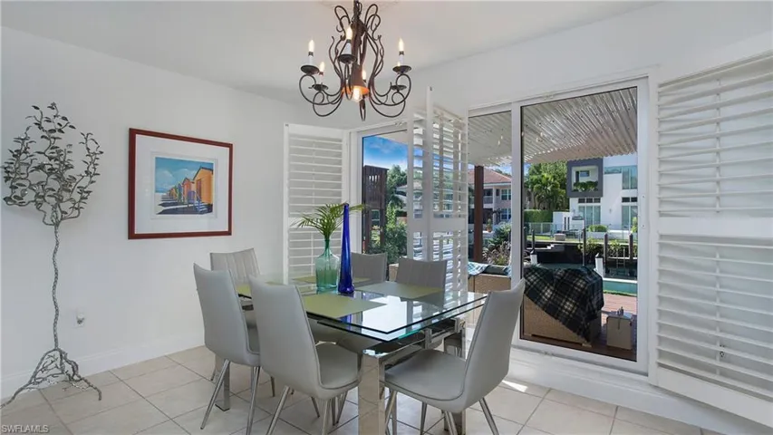 Tiled dining space featuring a chandelier
