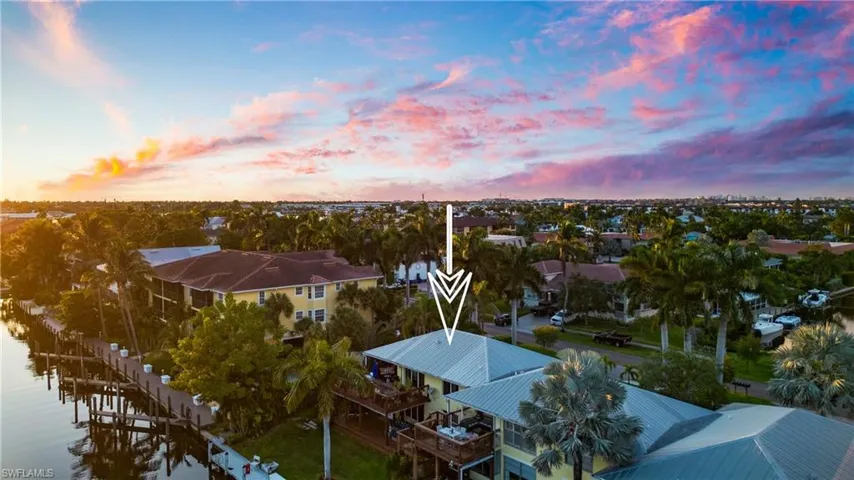 Aerial view at dusk featuring a water view