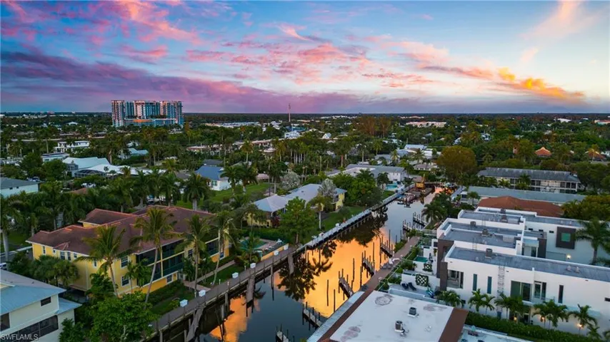 Aerial view at dusk featuring a water view