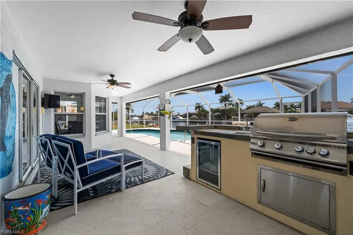 Outdoor kitchen with built in grill and beverage refrigerator