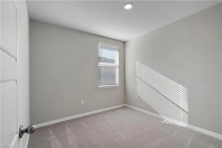 Empty room with carpet flooring