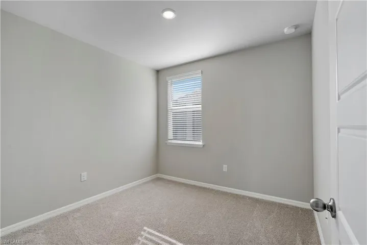 Unfurnished room with carpet