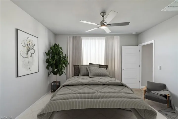 Bedroom with ceiling fan and light colored carpet