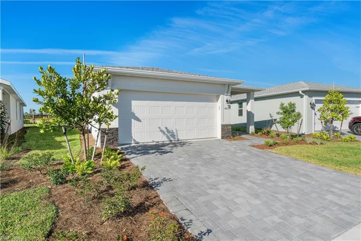 View of front of property featuring a front yard and a garage
