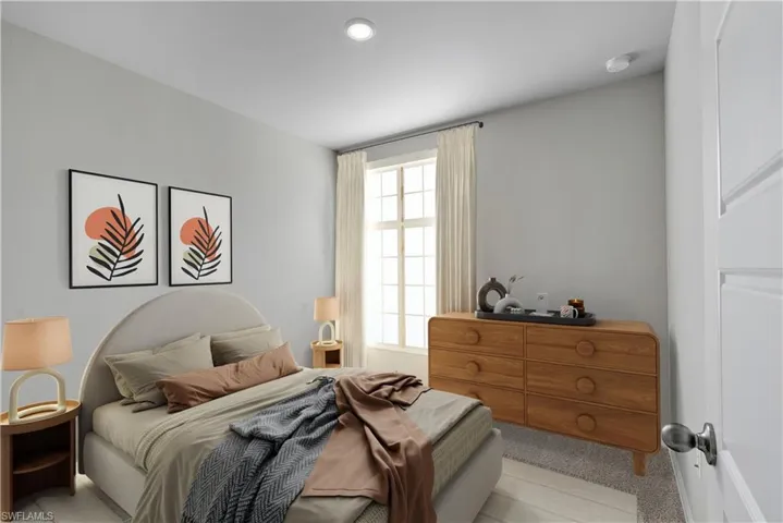 Bedroom featuring light carpet
