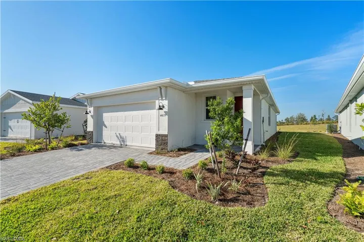 Single story home with a front yard and a garage