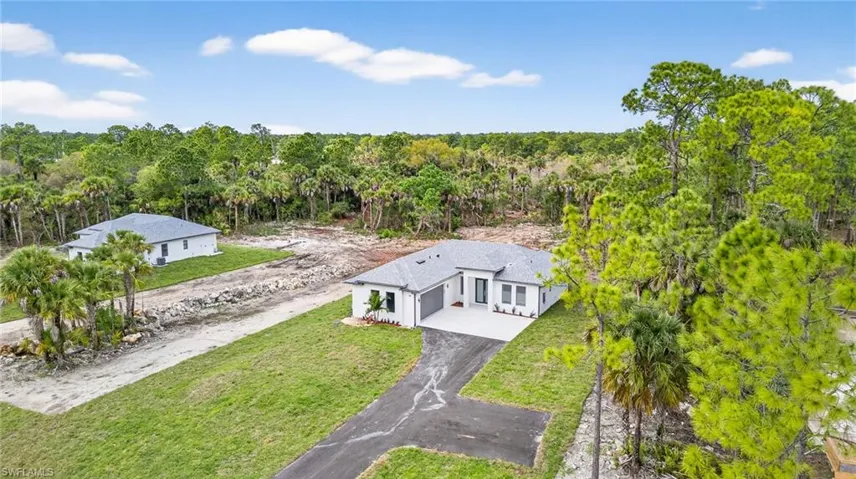 View of subject property with a heavily wooded area