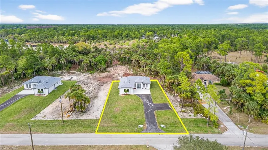 Aerial view of property's location with property parcel outlined and a heavily wooded area