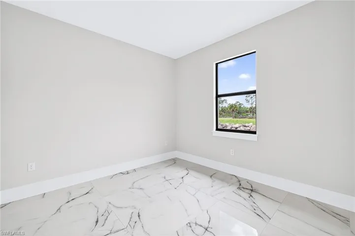 Unfurnished room with baseboards and marble finish floors