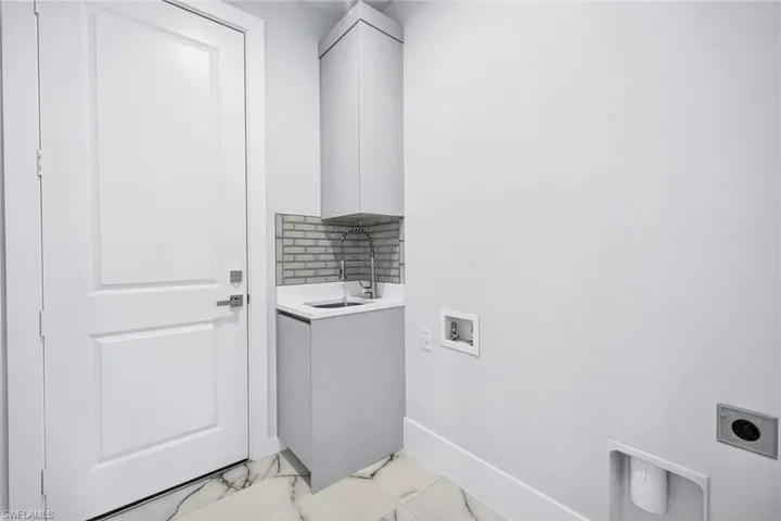 Laundry room with washer hookup, hookup for an electric dryer, and cabinet space
