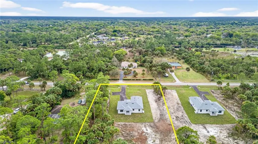 Aerial perspective of suburban area with property parcel outlined and a heavily wooded area