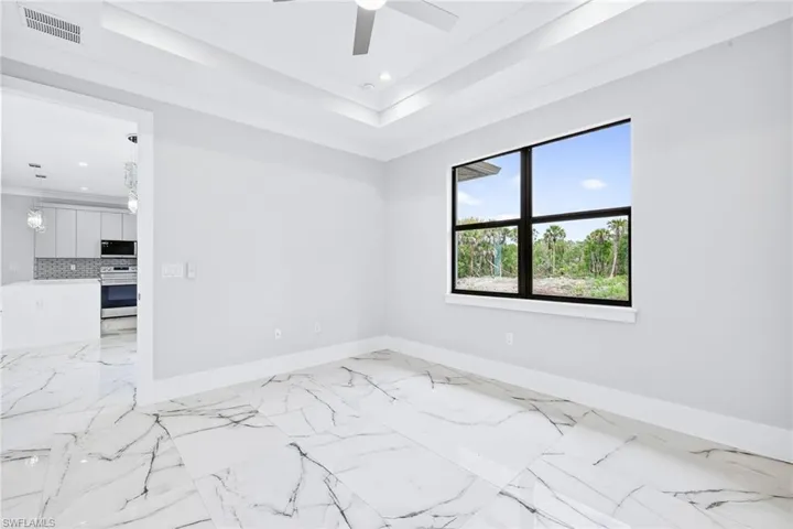 Spare room with ceiling fan, light marble finish flooring, and recessed lighting