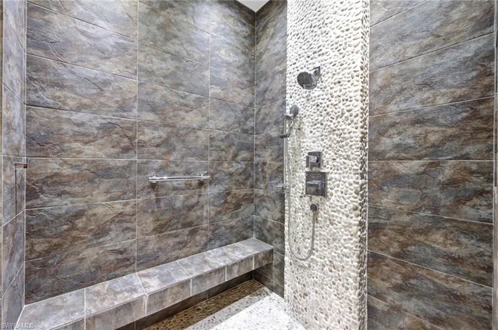Huge walk-in Shower with bench and high-end fixtures