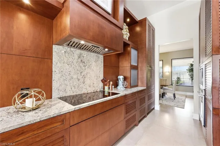 Beautifully remodeled Kitchen with custom European Craftsmanship Wood Cabinets, access to the Dining Room.