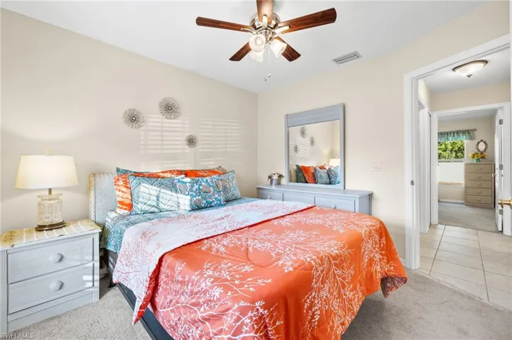Carpeted bedroom with ceiling fan