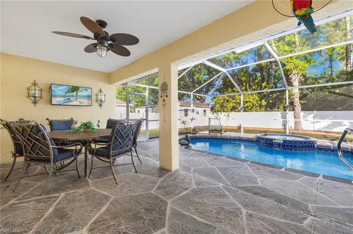 View of pool with an in ground hot tub, a patio, ceiling fan, and a lanai