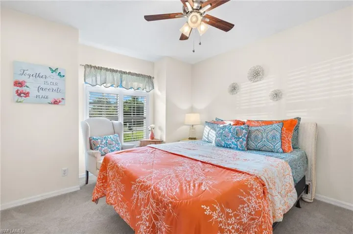 Carpeted bedroom with ceiling fan