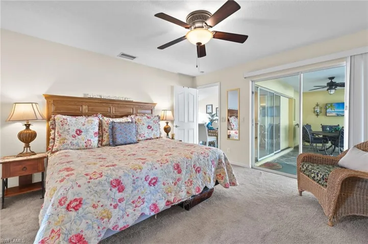 Carpeted bedroom with access to outside and ceiling fan