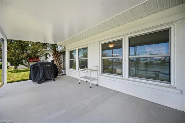 Expansive covered patio featuring a concrete surface, white soffit, and multiple windows