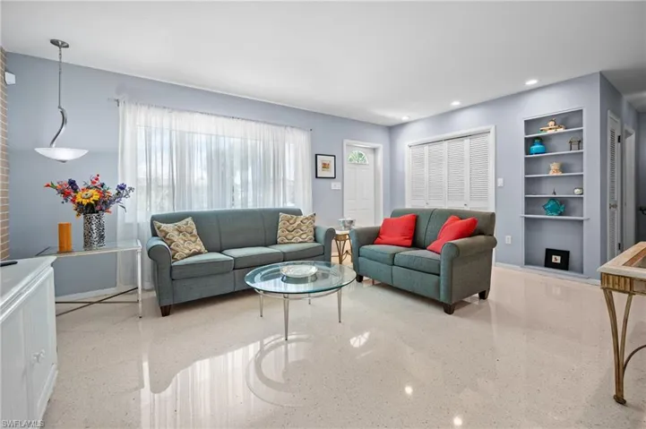 Bright living area featuring polished terrazzo flooring and pale blue walls