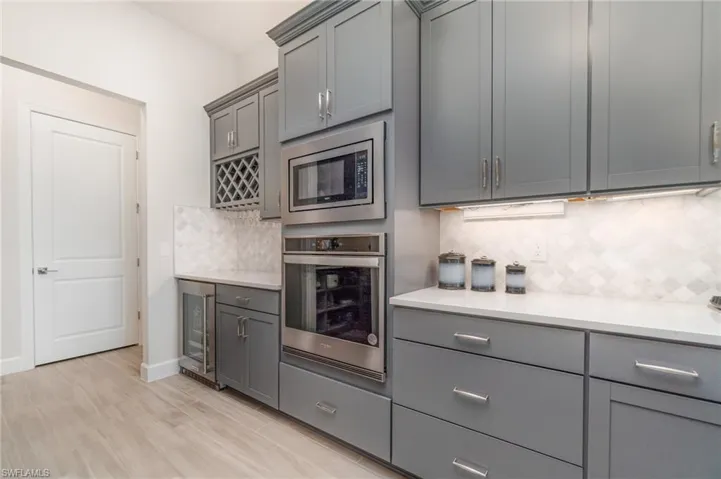 A true dream kitchen with 42" upper cabinets, roll out drawers and a beverage center perfect for entertaining!  Have we mentioned the gorgeous flooring?!