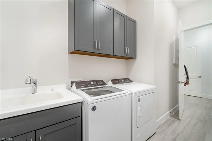 Storage galore with built in cabinetry in your new laundry room.  Laundry includes pass through to a secondary walk in closet and to the primary ensuite.