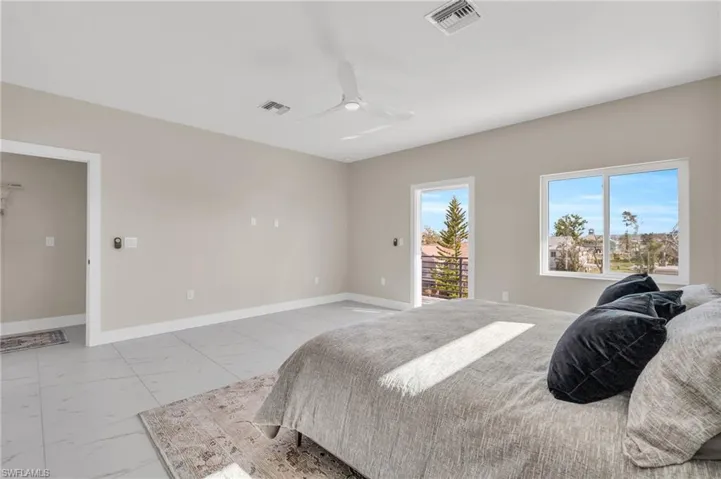 Bedroom with ceiling fan and access to outside /  virtually enhanced photo