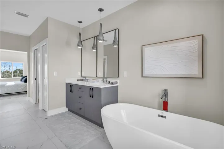 Bathroom with vanity and a bath /  virtually enhanced photo