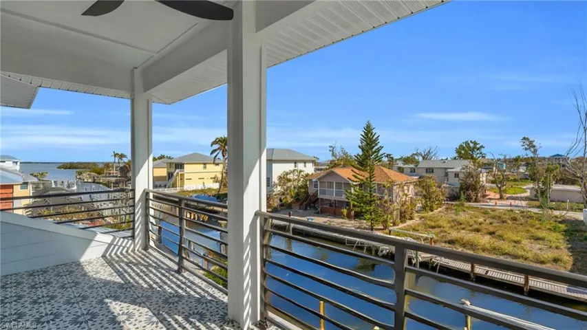 VIRTUALLY ENHANCED - Balcony with ceiling fan and a water view