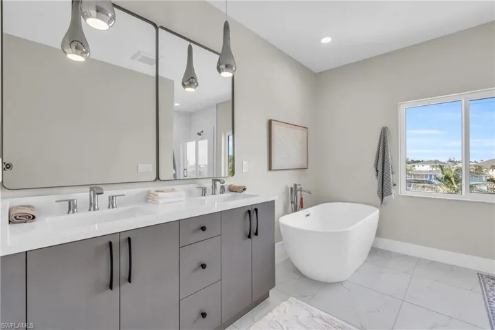 Bathroom with vanity and shower with separate bathtub /  virtually enhanced photo