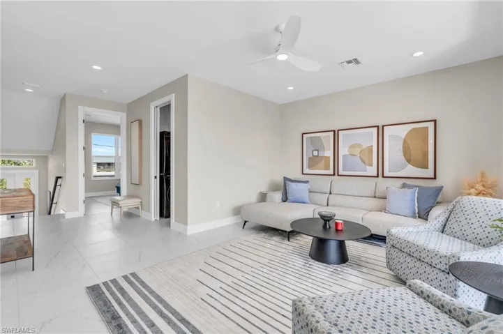 Living room with ceiling fan /  virtually enhanced photo
