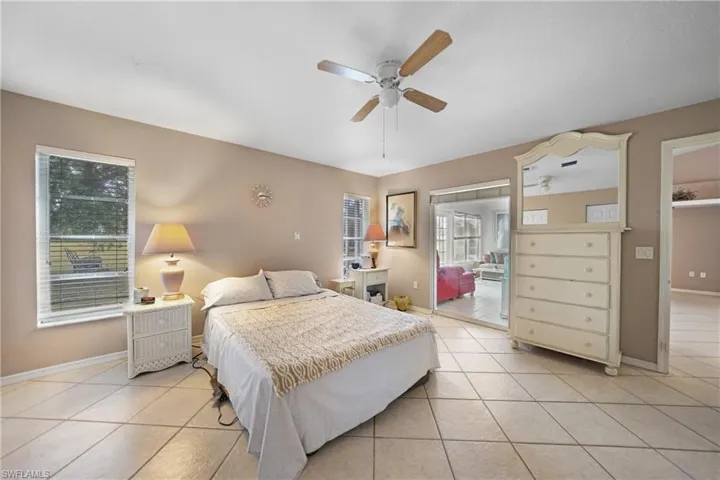 Bedroom with light tile patterned floors and ceiling fan